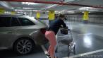 Hidden behind her car